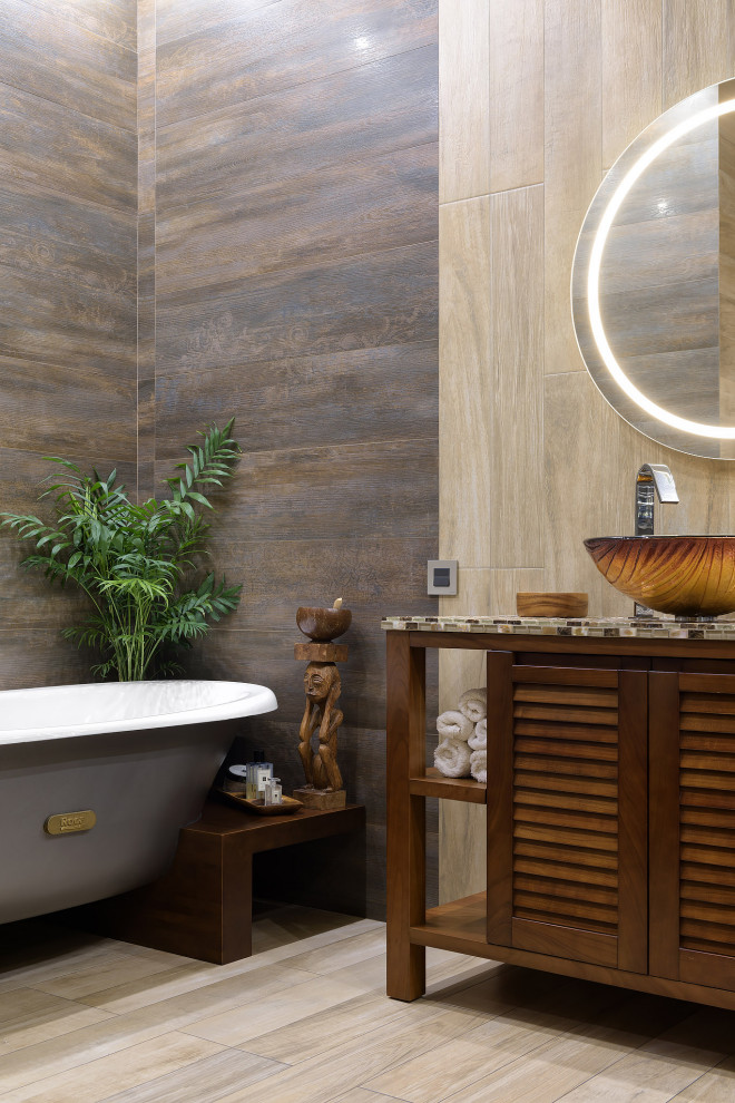Design ideas for a medium sized contemporary ensuite bathroom in Other with a hot tub, a corner shower, a one-piece toilet, beige tiles, ceramic tiles, beige walls, cement flooring, glass worktops, beige floors, a sliding door, beige worktops, an enclosed toilet, a single sink, a freestanding vanity unit and wood walls.