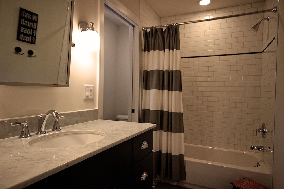 Bathroom - small traditional 3/4 white tile and subway tile concrete floor bathroom idea in Detroit with flat-panel cabinets, dark wood cabinets, a one-piece toilet, beige walls and an undermount sink