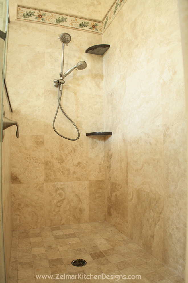 Example of a mid-sized classic master beige tile and stone tile travertine floor corner shower design in Orlando with an undermount sink, shaker cabinets, medium tone wood cabinets and quartz countertops