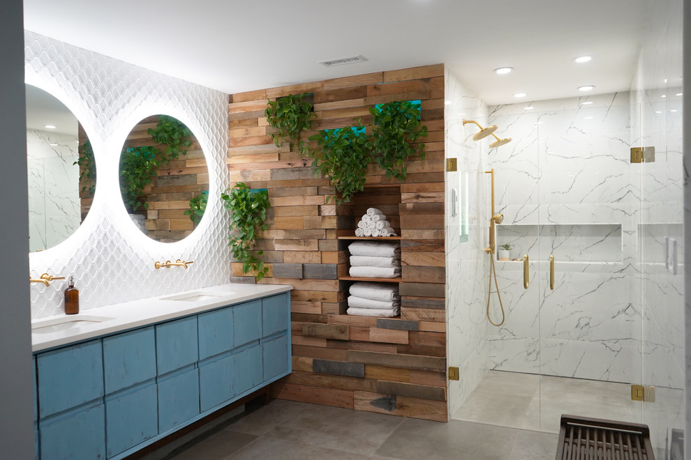 Inspiration for a large scandinavian master white tile and porcelain tile porcelain tile and gray floor bathroom remodel in Atlanta with flat-panel cabinets, blue cabinets, a one-piece toilet, blue walls, an undermount sink, quartz countertops, a hinged shower door and white countertops