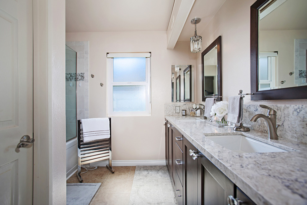 Example of a transitional master multicolored tile and ceramic tile ceramic tile and multicolored floor bathroom design in San Diego with pink walls, shaker cabinets, brown cabinets, an undermount sink, quartz countertops and a hinged shower door