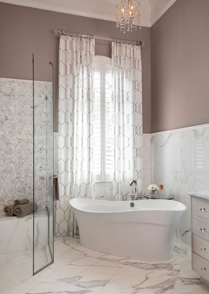 This is an example of a large classic ensuite bathroom in Miami with raised-panel cabinets, white cabinets, a freestanding bath, a corner shower, multi-coloured tiles, ceramic tiles, brown walls, marble flooring, a submerged sink, marble worktops, multi-coloured floors, a hinged door and multi-coloured worktops.