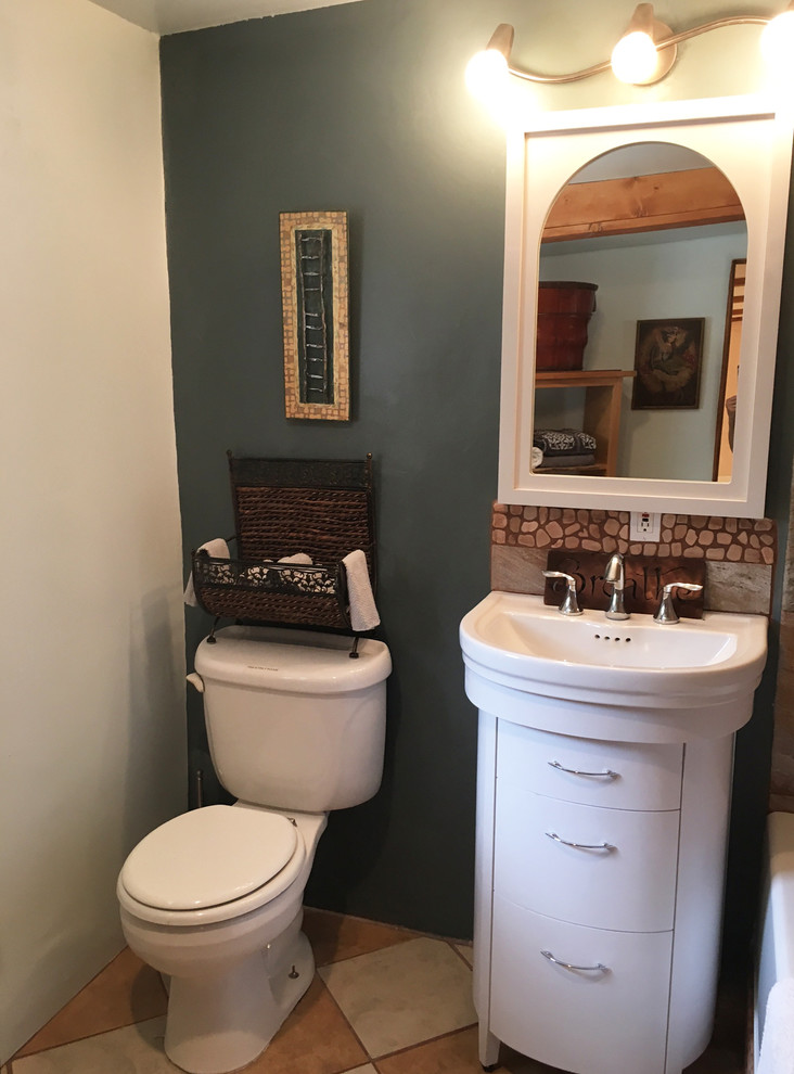 Small elegant master beige tile and ceramic tile ceramic tile bathroom photo in Albuquerque with furniture-like cabinets, white cabinets, a two-piece toilet, blue walls and a console sink
