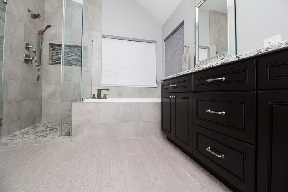 This is an example of a medium sized classic ensuite bathroom in Houston with dark wood cabinets, a built-in bath, a corner shower, grey tiles, porcelain tiles, grey walls, porcelain flooring, a submerged sink, engineered stone worktops, grey floors, a hinged door and beaded cabinets.