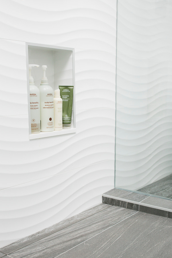 Modern shower room bathroom in Vancouver with a vessel sink, flat-panel cabinets, brown cabinets, quartz worktops, a freestanding bath, a double shower, a one-piece toilet, white tiles, white walls and porcelain flooring.