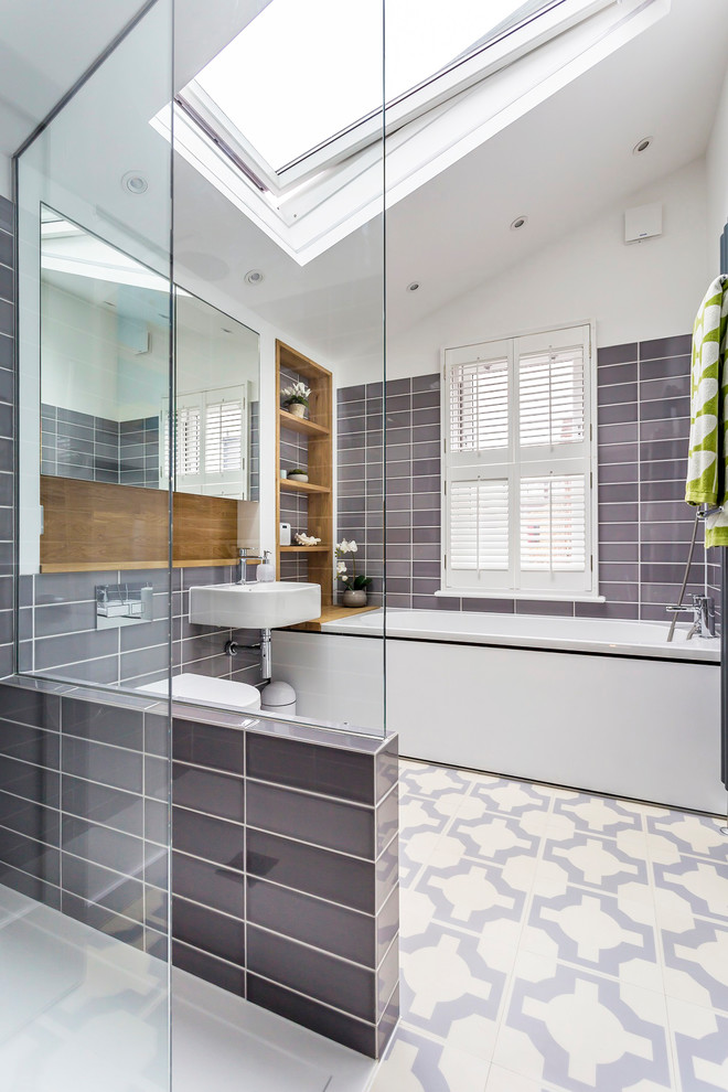 Small contemporary family bathroom in Other with glass-front cabinets, a built-in bath, a walk-in shower, a wall mounted toilet, ceramic tiles, white walls, vinyl flooring, a wall-mounted sink and multi-coloured floors.