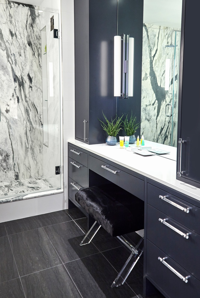 Example of a small transitional master white tile and stone slab porcelain tile and black floor bathroom design in New York with flat-panel cabinets, black cabinets, a one-piece toilet, white walls, an undermount sink, solid surface countertops and a hinged shower door