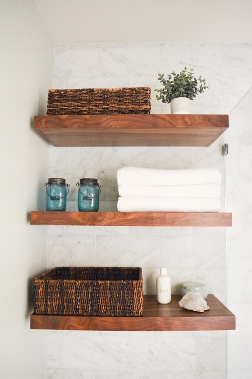 Open wooden shelves for guest bathrooms cabinets storage with towels, baskets, and decor items