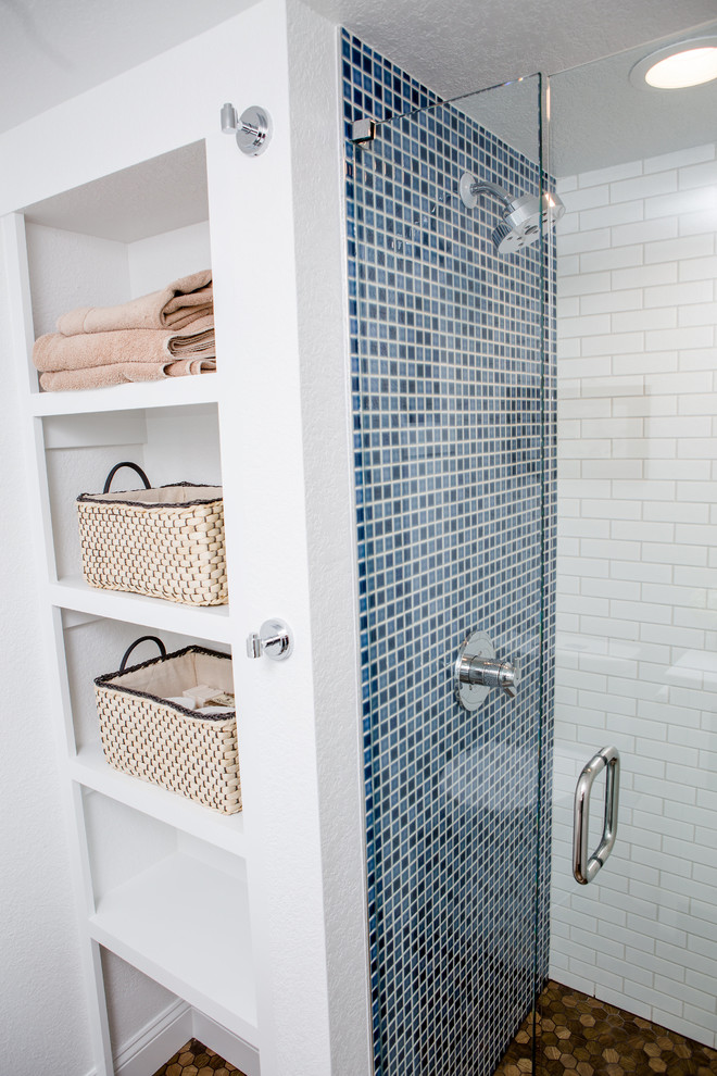 Photo of a large traditional shower room bathroom in Denver with shaker cabinets, white cabinets, a one-piece toilet, white tiles, ceramic tiles, white walls, porcelain flooring, an integrated sink, engineered stone worktops, brown floors and white worktops.