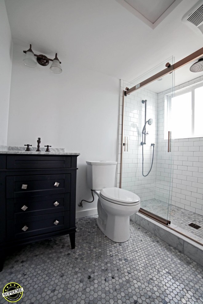 Источник вдохновения для домашнего уюта: маленькая ванная комната в стиле модернизм с фасадами в стиле шейкер, черными фасадами, душем в нише, унитазом-моноблоком, белой плиткой, керамической плиткой, белыми стенами, полом из галечной плитки, душевой кабиной, накладной раковиной, столешницей из гранита, серым полом, душем с раздвижными дверями и серой столешницей для на участке и в саду