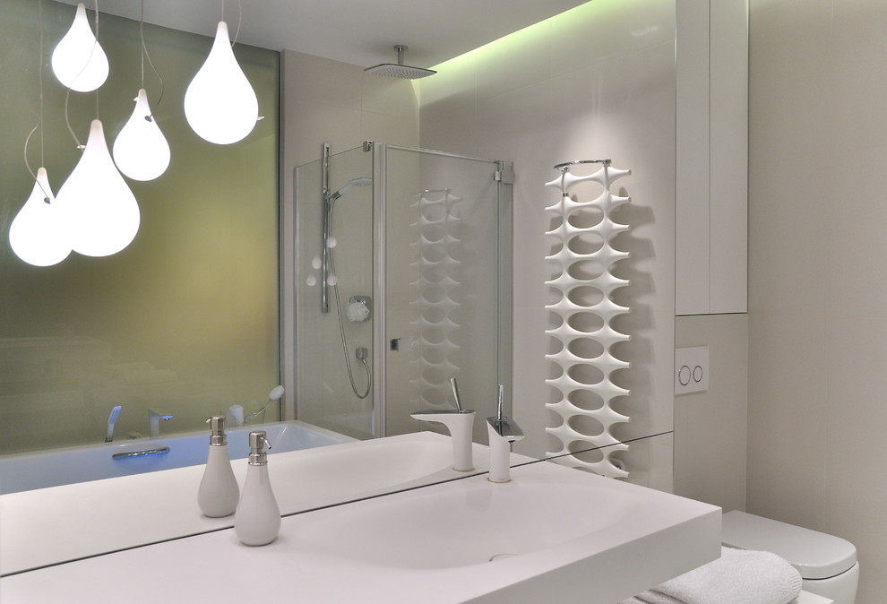 Medium sized contemporary ensuite bathroom in Other with a wall mounted toilet, flat-panel cabinets, white cabinets, a freestanding bath, a corner shower, white walls, an integrated sink and solid surface worktops.