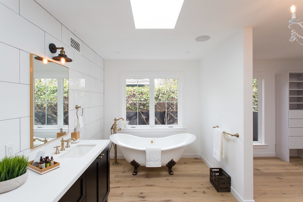 Example of a farmhouse master white tile claw-foot bathtub design in Los Angeles with shaker cabinets and black cabinets