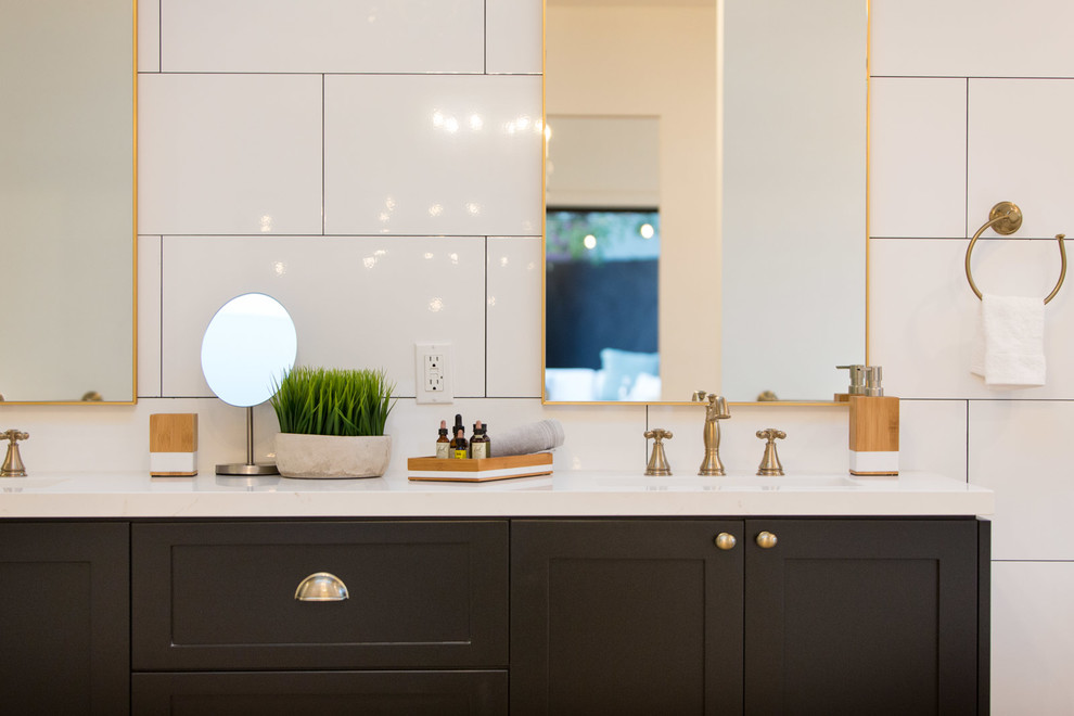 Claw-foot bathtub - cottage master white tile claw-foot bathtub idea in Los Angeles with shaker cabinets, black cabinets and white walls
