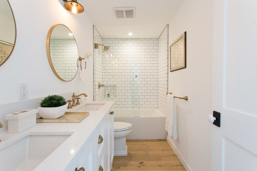 Example of a cottage kids' white tile alcove bathtub design in Los Angeles with shaker cabinets, white cabinets and white walls