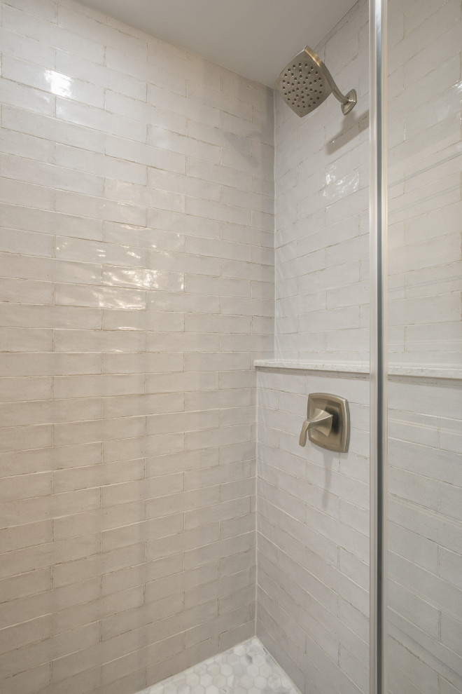 Photo of an expansive coastal shower room bathroom in Milwaukee with freestanding cabinets, brown cabinets, a corner shower, white tiles, ceramic tiles, engineered stone worktops, a hinged door, a single sink, a freestanding vanity unit, a one-piece toilet, a submerged sink, grey walls, ceramic flooring, white floors and multi-coloured worktops.