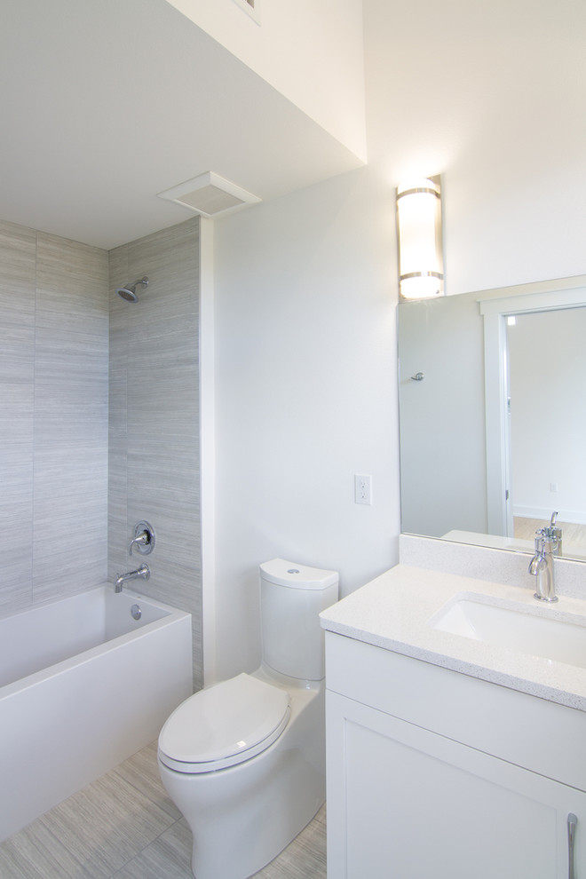 Bathroom - small contemporary multicolored tile and porcelain tile porcelain tile bathroom idea in Tampa with shaker cabinets, white cabinets, a two-piece toilet, white walls, an undermount sink and quartz countertops