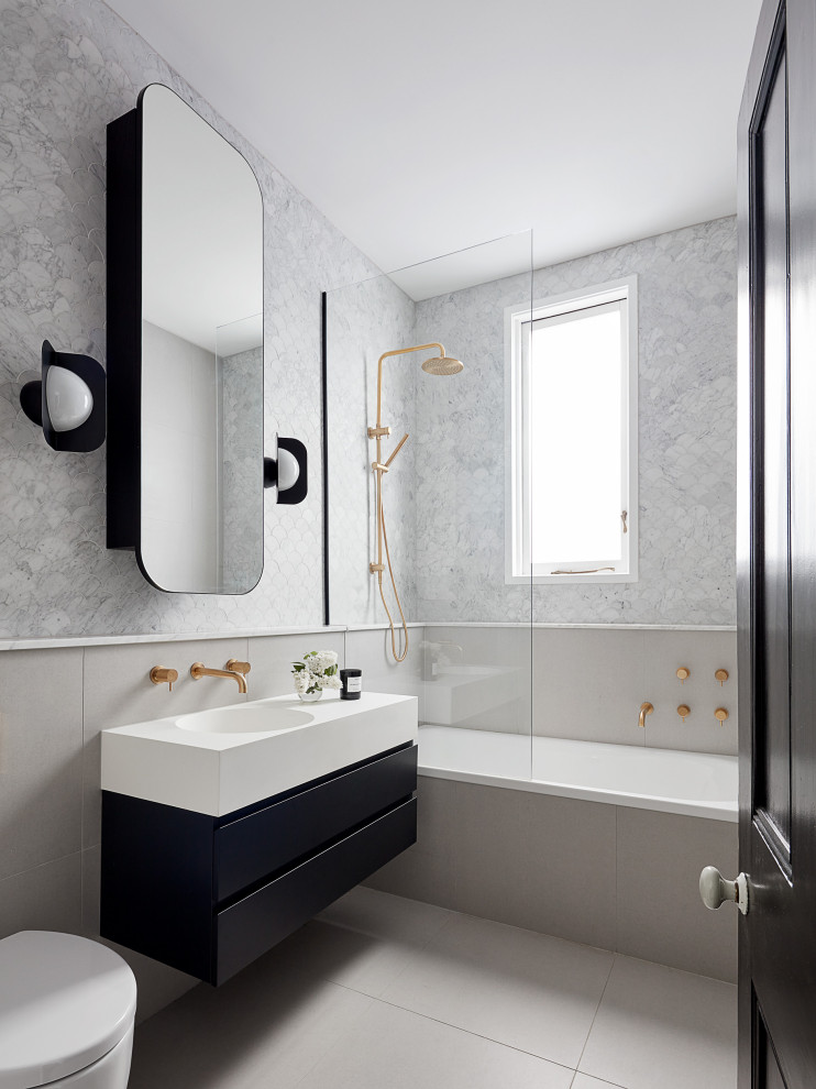 This is an example of a medium sized contemporary shower room bathroom in Melbourne with flat-panel cabinets, black cabinets, a wall mounted toilet, grey tiles, an integrated sink, grey floors, white worktops, a single sink and a floating vanity unit.