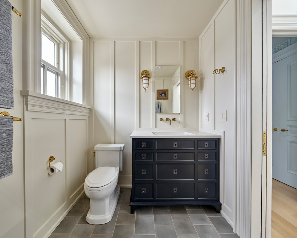 Bathroom - transitional gray floor, single-sink and wall paneling bathroom idea in Philadelphia with recessed-panel cabinets, black cabinets, white walls, an undermount sink, white countertops and a freestanding vanity