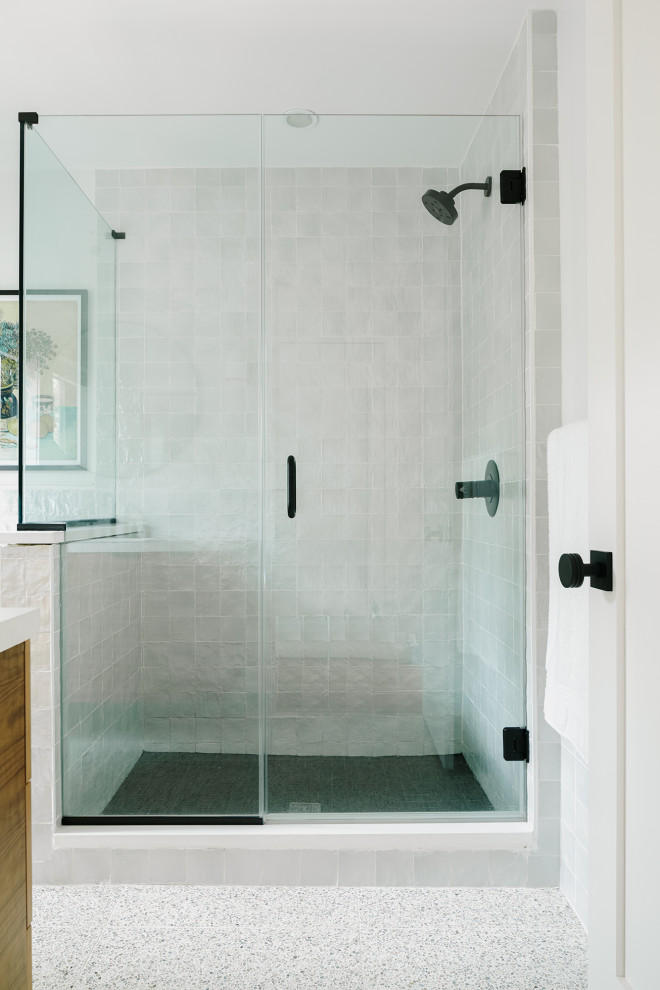 Inspiration for a mid-sized contemporary master gray tile and ceramic tile terrazzo floor and gray floor doorless shower remodel in Philadelphia with flat-panel cabinets, brown cabinets, a two-piece toilet, white walls, an integrated sink, concrete countertops, a hinged shower door and white countertops