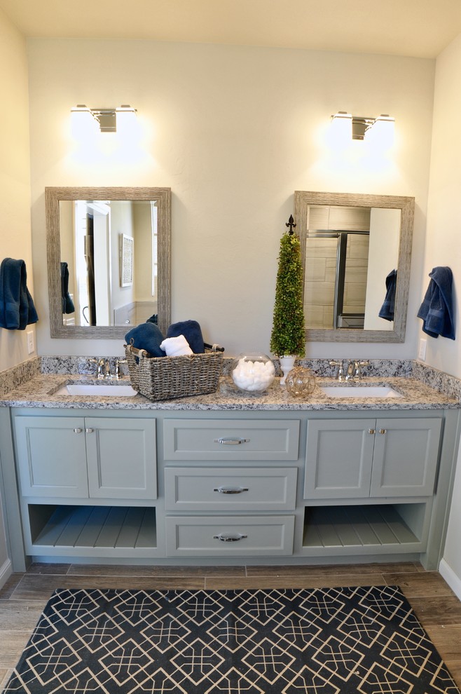 Photo of a farmhouse ensuite bathroom in Oklahoma City with shaker cabinets, green cabinets, a corner shower, brown tiles, ceramic flooring, a submerged sink and granite worktops.