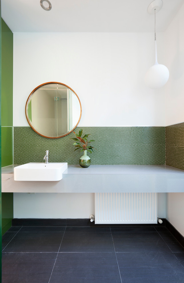 Example of a mid-sized trendy green tile and glass tile black floor, single-sink and ceramic tile freestanding bathtub design in Melbourne with white walls, gray countertops, gray cabinets, solid surface countertops, a floating vanity, a drop-in sink and a hinged shower door