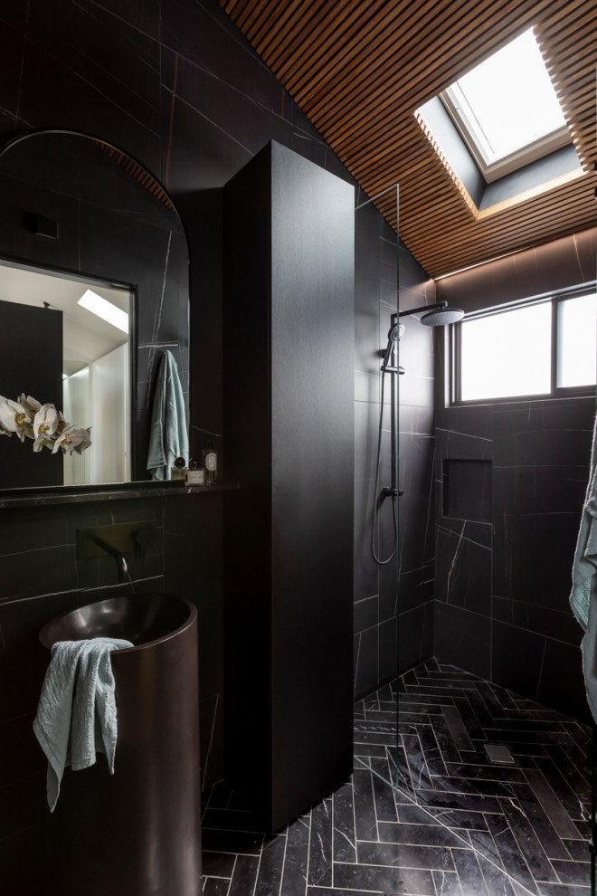 This is an example of a medium sized contemporary shower room bathroom in Sydney with black cabinets, a walk-in shower, black tiles, black walls, an integrated sink, black floors, black worktops, a wall niche, a single sink and a freestanding vanity unit.