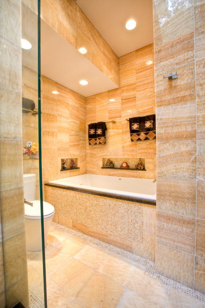 Large world-inspired ensuite bathroom in Bridgeport with a vessel sink, flat-panel cabinets, dark wood cabinets, granite worktops, a built-in bath, a double shower, a two-piece toilet, yellow tiles, stone tiles, yellow walls and mosaic tile flooring.