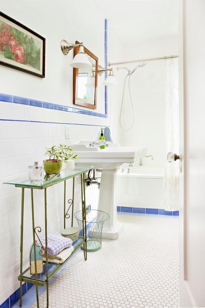 This is an example of a small vintage bathroom in Los Angeles with white cabinets, blue tiles, a pedestal sink, an alcove bath, ceramic tiles, white walls and ceramic flooring.