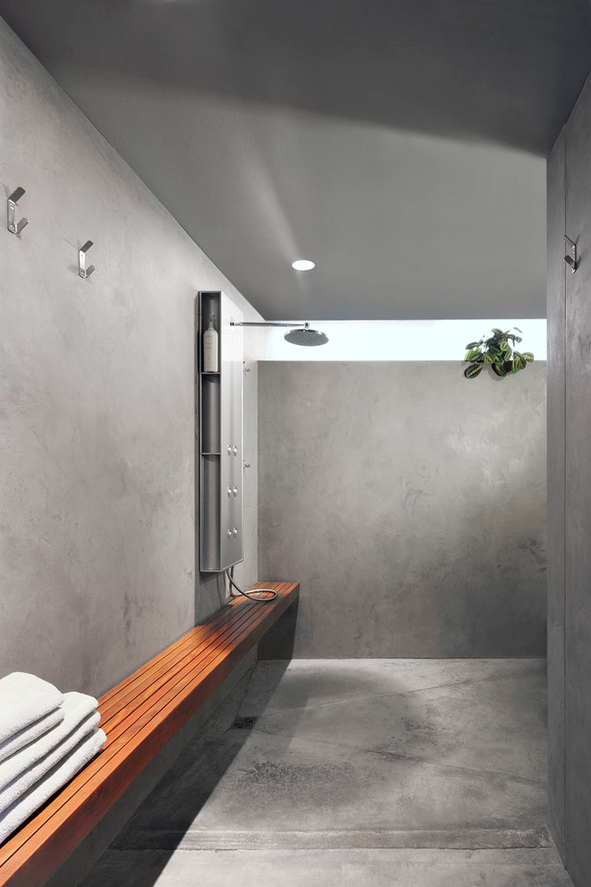 Diseño de cuarto de baño cemento contemporáneo con ducha abierta, suelo de cemento, paredes grises, ducha abierta y banco de ducha