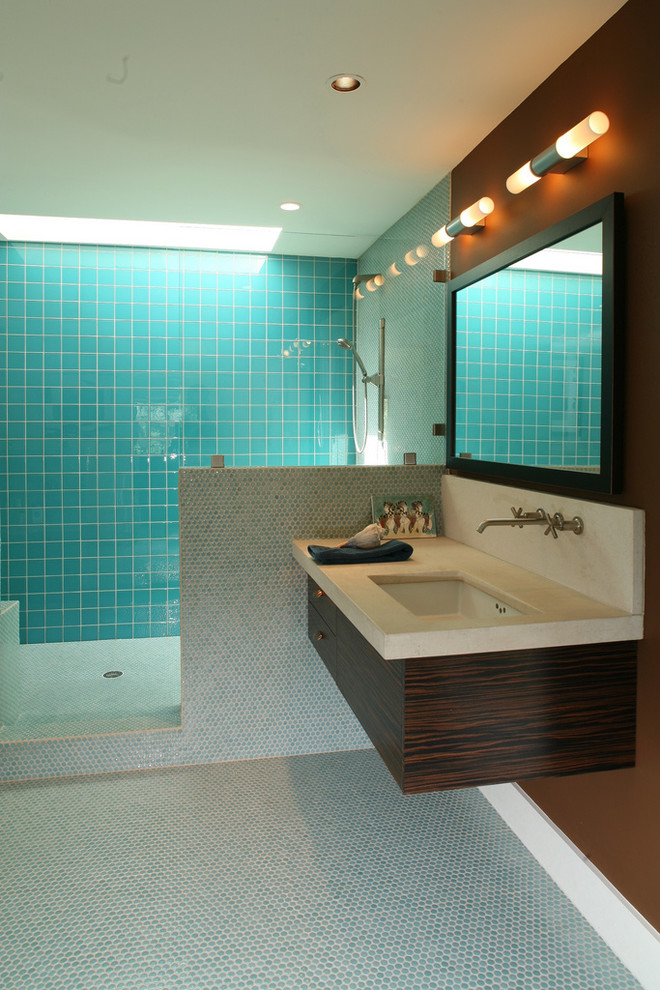Medium sized contemporary grey and teal bathroom in Austin with mosaic tiles, blue tiles, flat-panel cabinets, dark wood cabinets, an alcove shower, brown walls, mosaic tile flooring, a submerged sink, limestone worktops and beige worktops.