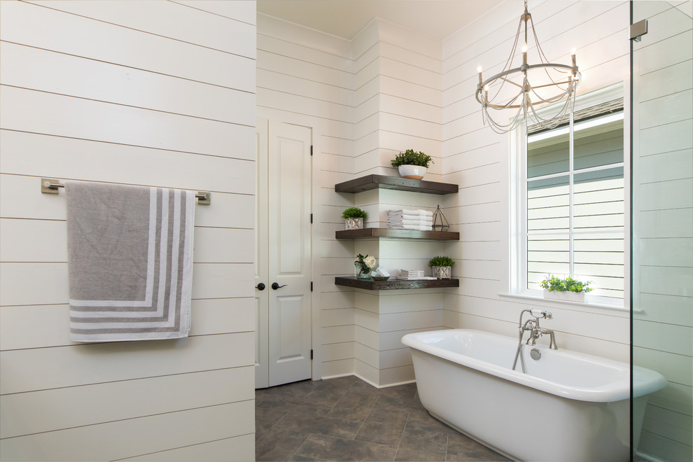 На фото: главная ванная комната среднего размера в современном стиле с отдельно стоящей ванной, угловым душем, душем с распашными дверями, белой столешницей, белыми стенами, полом из мозаичной плитки и коричневым полом с