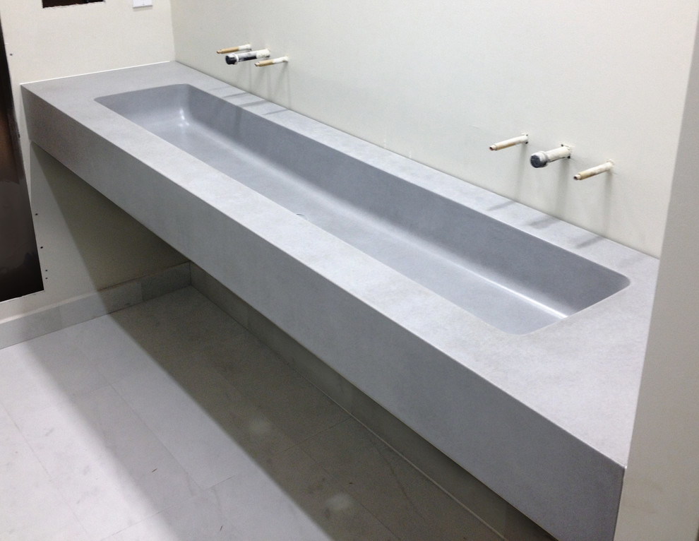 Design ideas for a contemporary bathroom in New York with a wall-mounted sink and concrete worktops.
