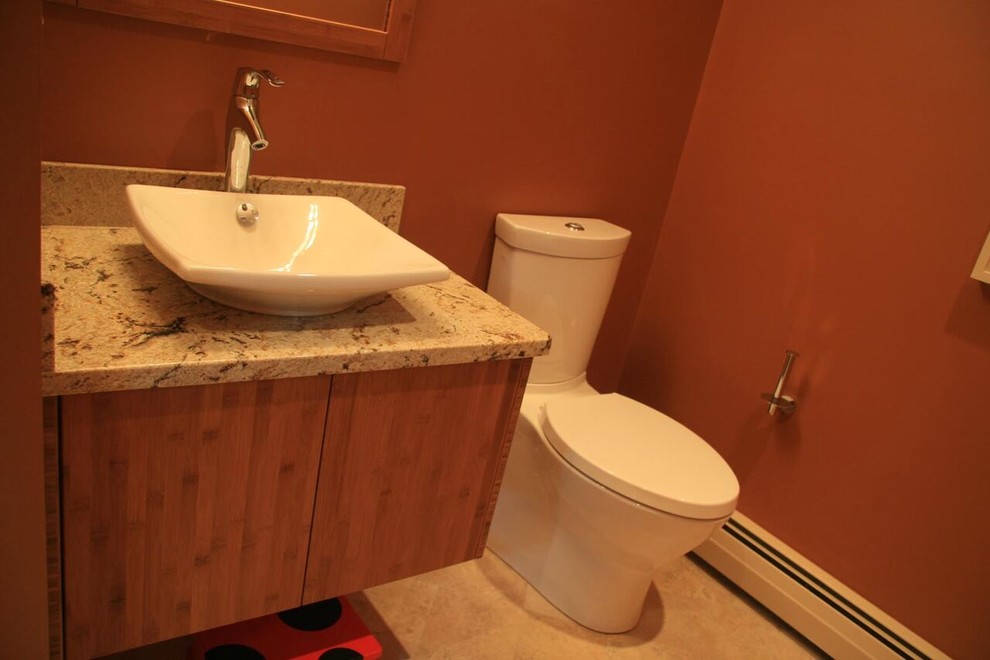 Diseño de cuarto de baño actual pequeño con armarios con paneles lisos, puertas de armario de madera oscura, sanitario de dos piezas, paredes rojas, suelo de piedra caliza, lavabo sobreencimera, encimera de granito y suelo beige