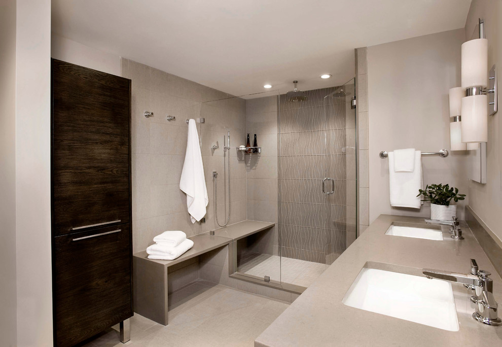 Photo of a large modern ensuite bathroom in Boston with a submerged sink, flat-panel cabinets, dark wood cabinets, engineered stone worktops, a double shower, beige tiles, porcelain tiles, beige walls and porcelain flooring.