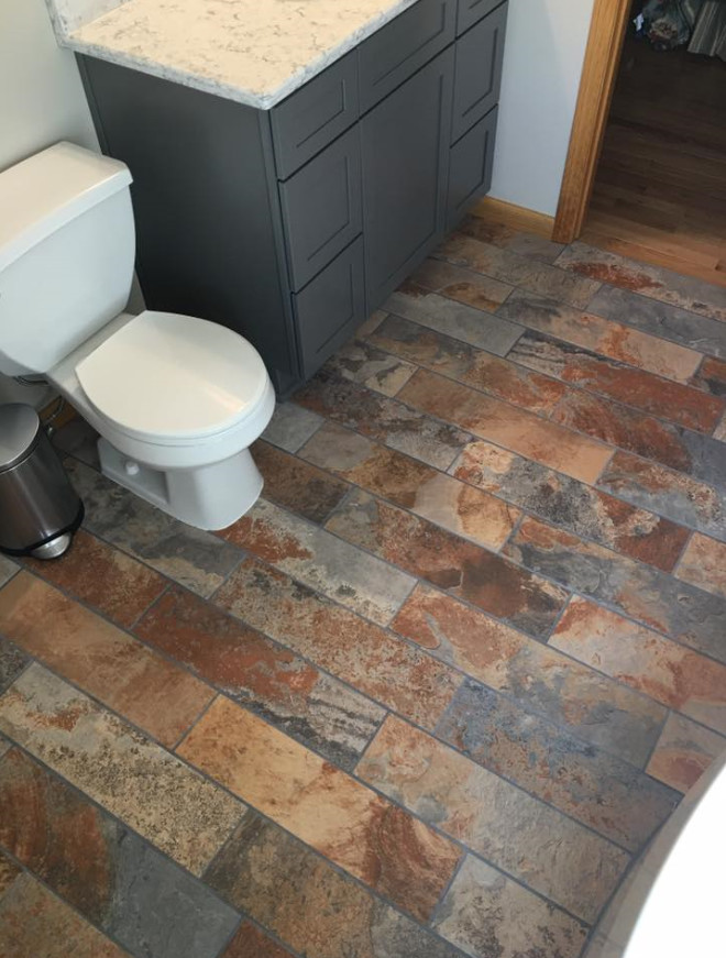 Bathroom - mid-sized contemporary 3/4 gray tile and slate tile slate floor bathroom idea in Cleveland with shaker cabinets, gray cabinets, blue walls and quartz countertops