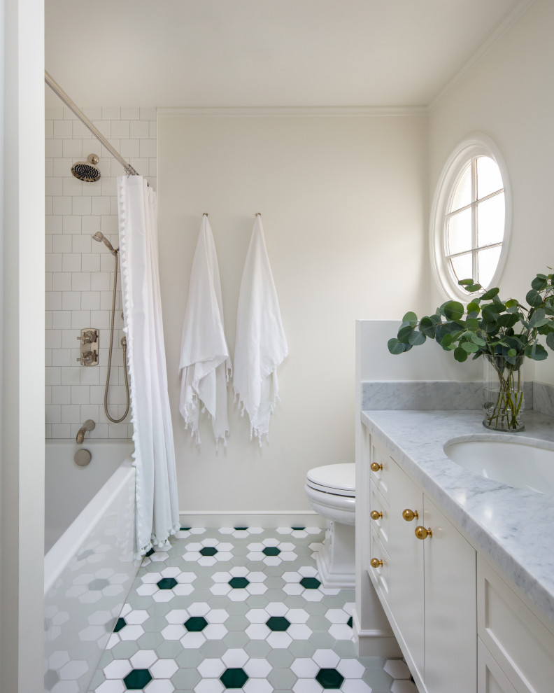 Aménagement d'une salle de bain principale classique de taille moyenne avec une baignoire en alcôve, un combiné douche/baignoire, un carrelage blanc, des carreaux de céramique, un mur blanc, un sol en carrelage de céramique, un plan de toilette en marbre, un sol vert, une cabine de douche avec un rideau et un plan de toilette blanc.