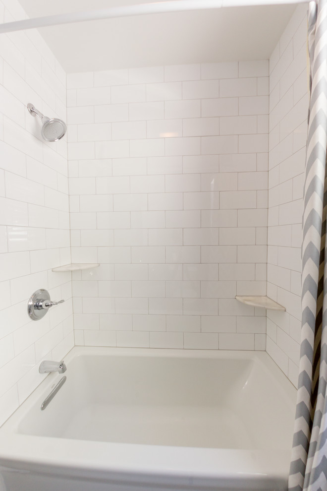 Example of a small trendy white tile and porcelain tile porcelain tile bathroom design in New York with recessed-panel cabinets, gray cabinets, solid surface countertops and gray walls