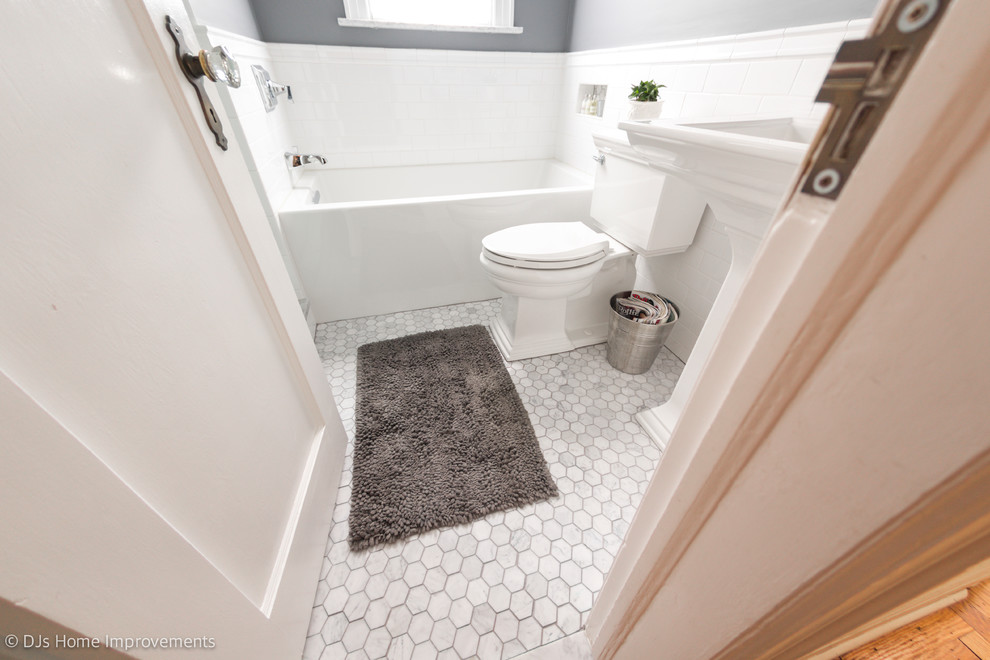 Photo of a small contemporary bathroom in New York with an alcove bath, an alcove shower, a two-piece toilet, white tiles, porcelain tiles, grey walls, marble flooring, a pedestal sink, multi-coloured floors and a hinged door.