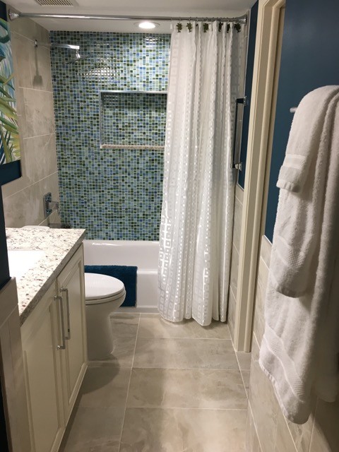 Bathroom - mid-sized tropical 3/4 blue tile and mosaic tile beige floor and cement tile floor bathroom idea in Other with raised-panel cabinets, gray walls, an undermount sink, granite countertops, white cabinets, a two-piece toilet and white countertops