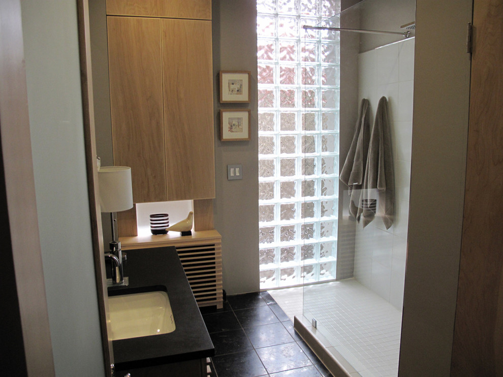 Exemple d'une salle de bain principale tendance en bois clair avec un placard à porte plane, une douche ouverte, WC séparés, un carrelage noir et blanc, des carreaux de béton, un mur gris, un sol en calcaire, un lavabo encastré et un plan de toilette en calcaire.