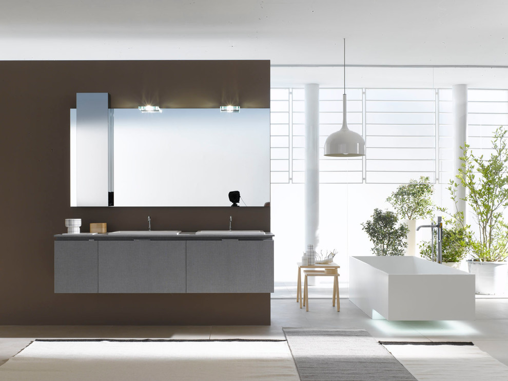 Design ideas for a large modern bathroom in Venice with a wall-mounted sink, flat-panel cabinets, grey cabinets, laminate worktops, white tiles, ceramic tiles, brown walls, ceramic flooring and a freestanding bath.