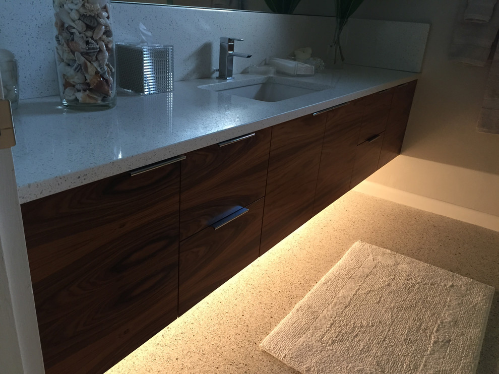 Design ideas for a medium sized modern ensuite bathroom in Miami with flat-panel cabinets, medium wood cabinets, a one-piece toilet, beige walls, a submerged sink, engineered stone worktops and beige floors.