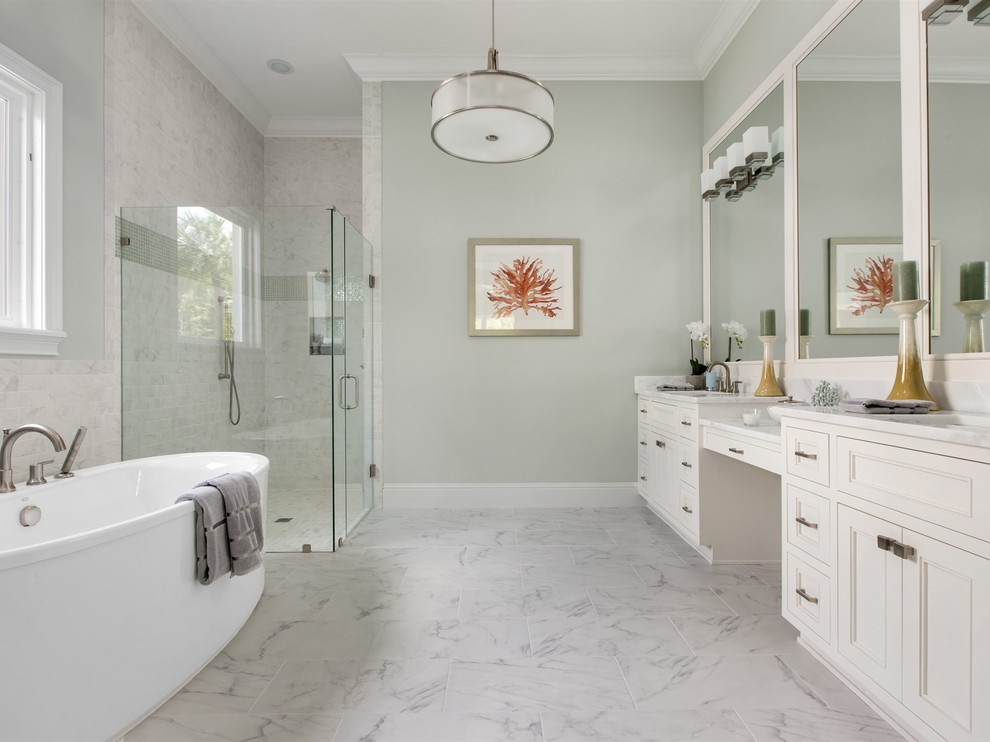 Example of a large transitional master gray tile and stone tile marble floor bathroom design in Orlando with recessed-panel cabinets, white cabinets, a one-piece toilet, green walls, an undermount sink and marble countertops