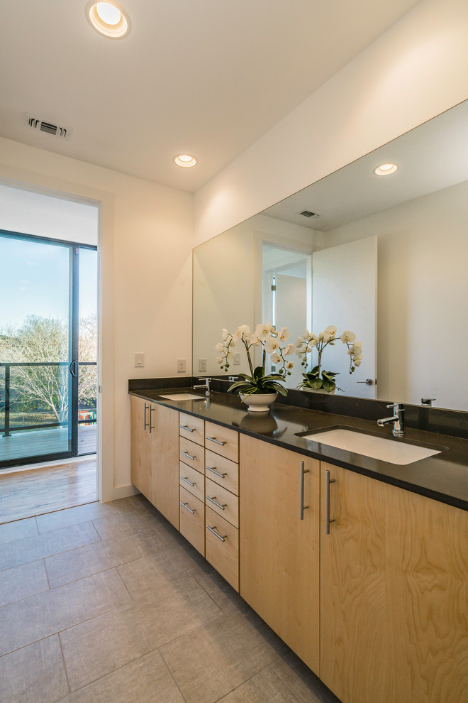Inspiration for a large contemporary family bathroom in Austin with flat-panel cabinets, light wood cabinets, a walk-in shower, white tiles, porcelain tiles, white walls, ceramic flooring, a submerged sink, engineered stone worktops, grey floors and an open shower.