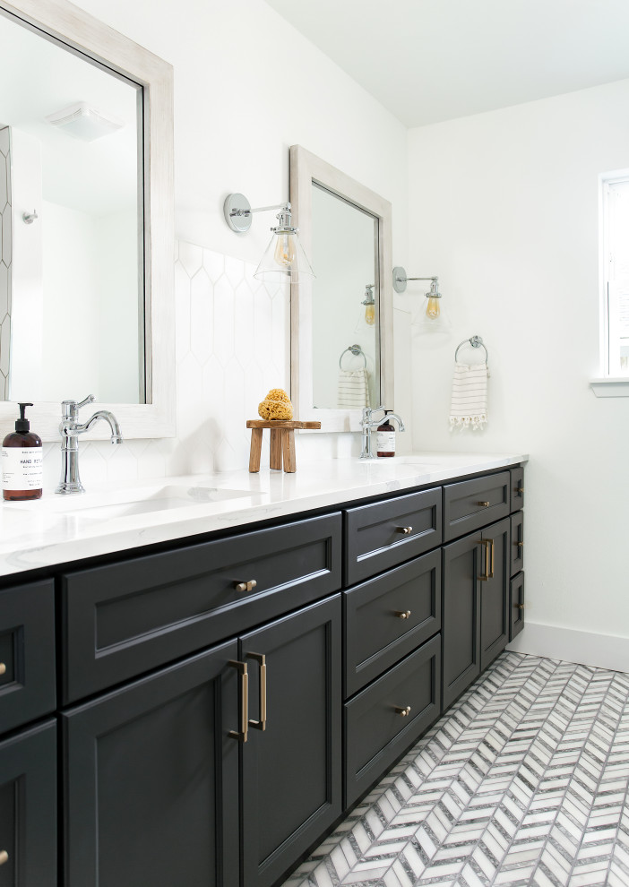 This is an example of a traditional half tiled bathroom in Dallas with recessed-panel cabinets, black cabinets, white walls, a submerged sink, multi-coloured floors, white worktops and double sinks.