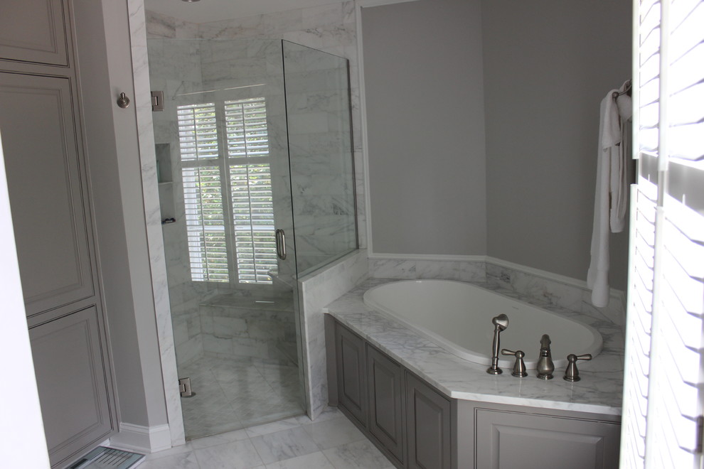 Inspiration for a large timeless master marble tile marble floor bathroom remodel in Birmingham with gray cabinets, gray walls, raised-panel cabinets and a hinged shower door