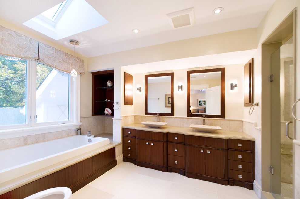Large elegant master beige tile and stone tile marble floor bathroom photo in Toronto with a vessel sink, flat-panel cabinets, medium tone wood cabinets, quartz countertops, a two-piece toilet and beige walls