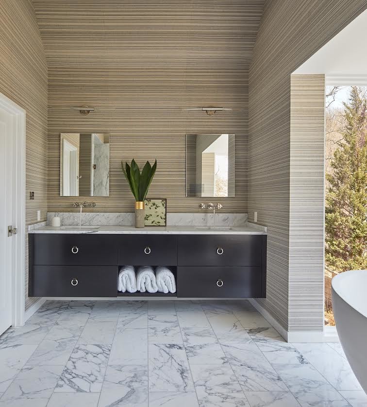 Cette photo montre une grande salle de bain principale tendance avec un placard à porte plane, des portes de placard noires, une baignoire indépendante, un mur marron, un sol en marbre, un lavabo encastré, un plan de toilette en surface solide, un sol gris et un plan de toilette gris.