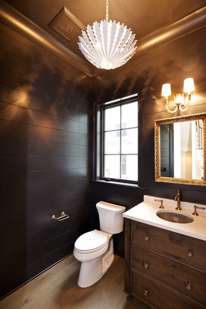 Example of a mid-sized mountain style 3/4 light wood floor bathroom design in Chicago with beaded inset cabinets, light wood cabinets, a two-piece toilet, black walls, an undermount sink and solid surface countertops