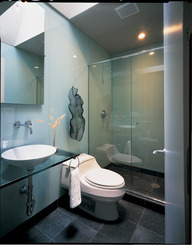 Example of a minimalist gray tile alcove shower design in DC Metro with a vessel sink and glass countertops